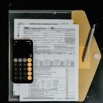 Notebook showing a zero based budgeting template calculation where income minus expenses equals zero balance
