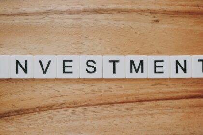 Investing and markets for beginners: a person studying a price chart on a laptop at a desk